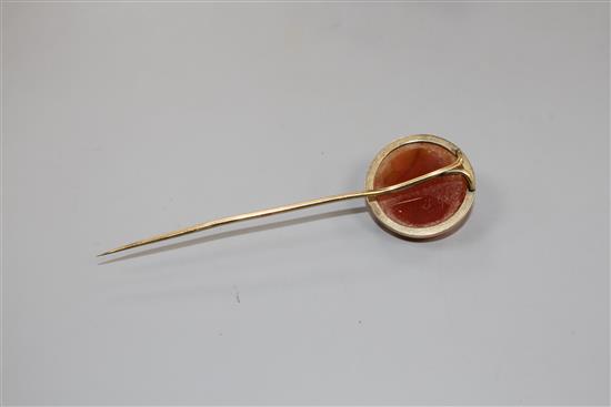 An early 20th century yellow metal and carnelian cameo set stick pin.